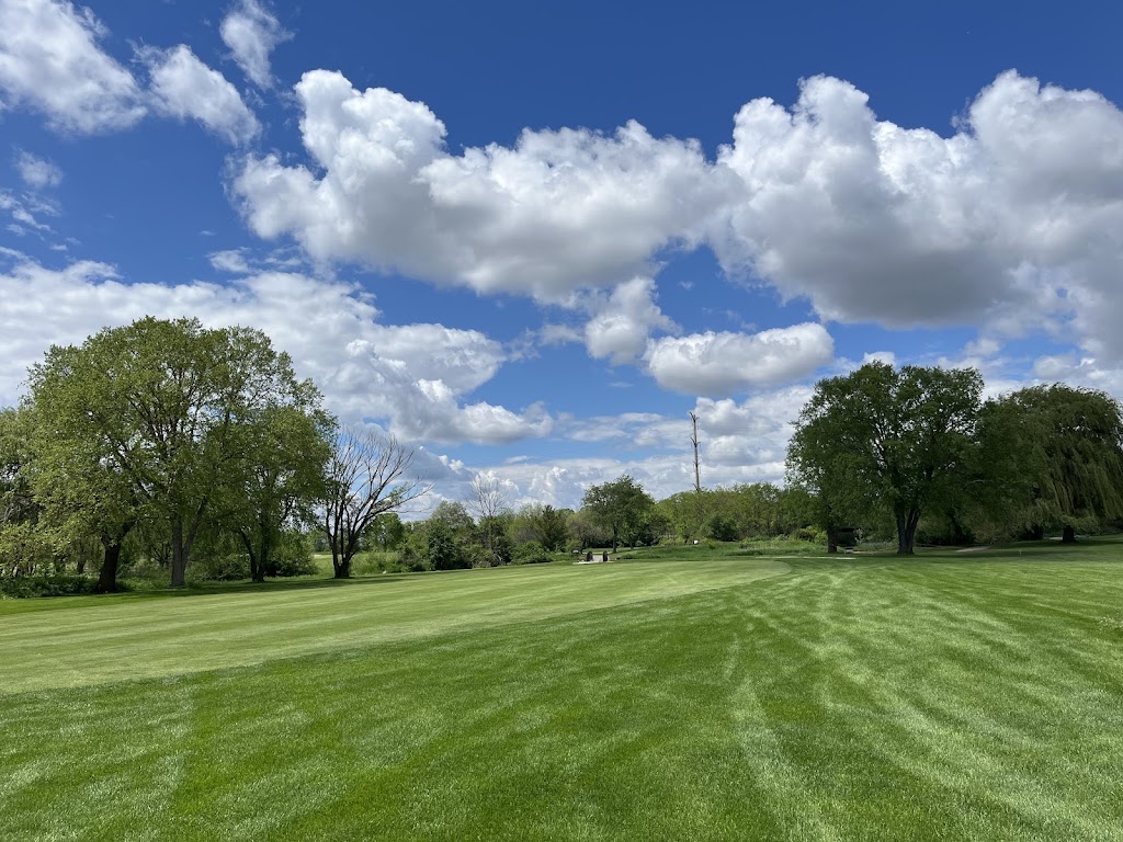 Panoramic view of a lush green golf course at Blackberry Oaks Golf Course. Smooth