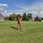green grass with the flag in the hole.