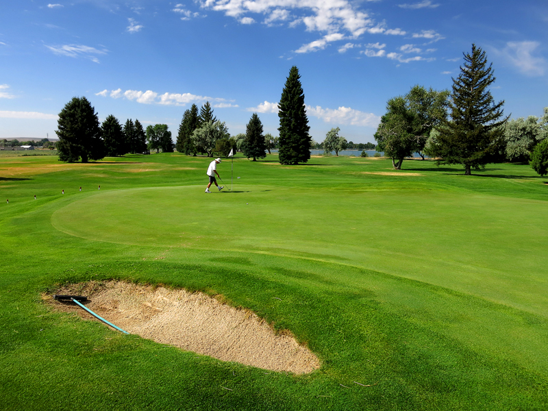 Panoramic view of a lush green golf course at Blackfoot Golf Course. Smooth