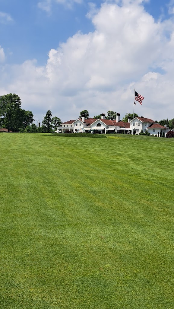 Panoramic view of a lush green golf course at Blind Brook Club. Smooth