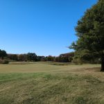 Panoramic view of a lush green golf course at Blue Heron Golf Course. Smooth