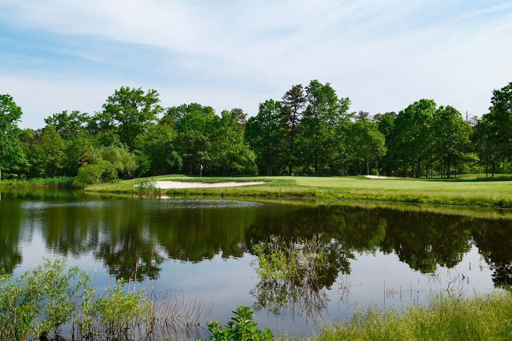 Panoramic view of a lush green golf course at Blue Heron Pines Golf Club. Smooth
