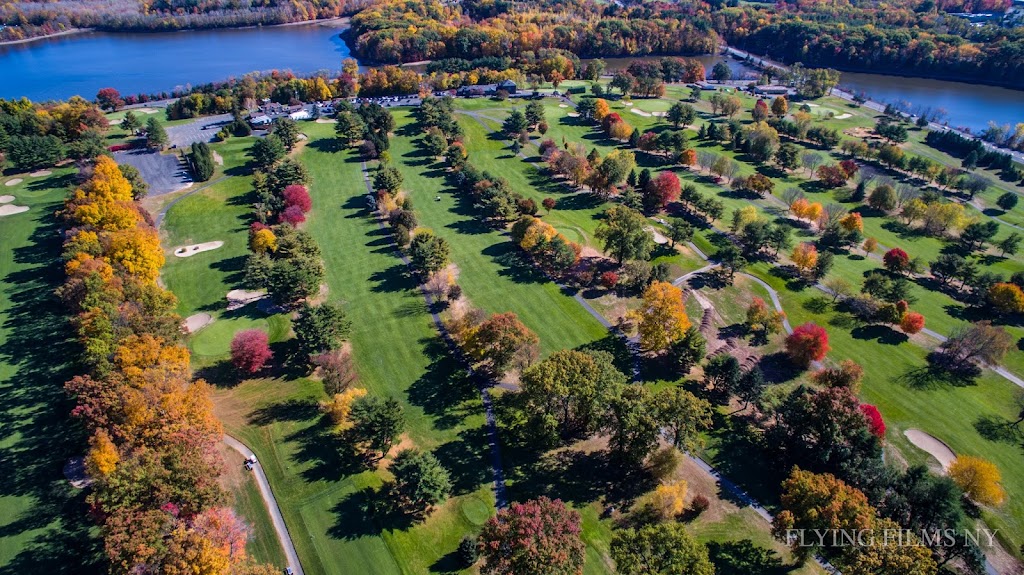 Panoramic view of a lush green golf course at Blue Hill Golf Course. Smooth