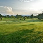 Panoramic view of a lush green golf course at Blue Hills Golf Club. Smooth
