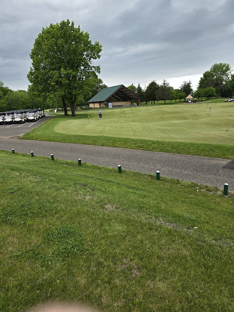 Panoramic view of a lush green golf course at Bluff Creek Golf Course. Smooth