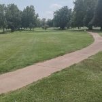 Panoramic view of a lush green golf course at Bolivar Golf Course. Smooth