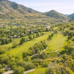Panoramic view of a lush green golf course at Bonneville Golf Course. Smooth