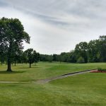 Panoramic view of a lush green golf course at Bonnie Brook Golf Course. Smooth