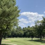 Panoramic view of a lush green golf course at Bowie Golf Club. Smooth