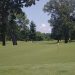 Panoramic view of a lush green golf course at Brainerd Golf Course. Smooth