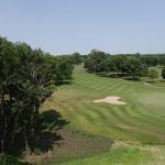 Panoramic view of a lush green golf course at Brandon Golf Course. Smooth