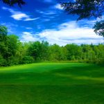 Panoramic view of a lush green golf course at Breakfast Hill Golf Club. Smooth