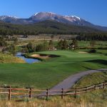 Panoramic view of a lush green golf course at Breckenridge Golf Club. Smooth