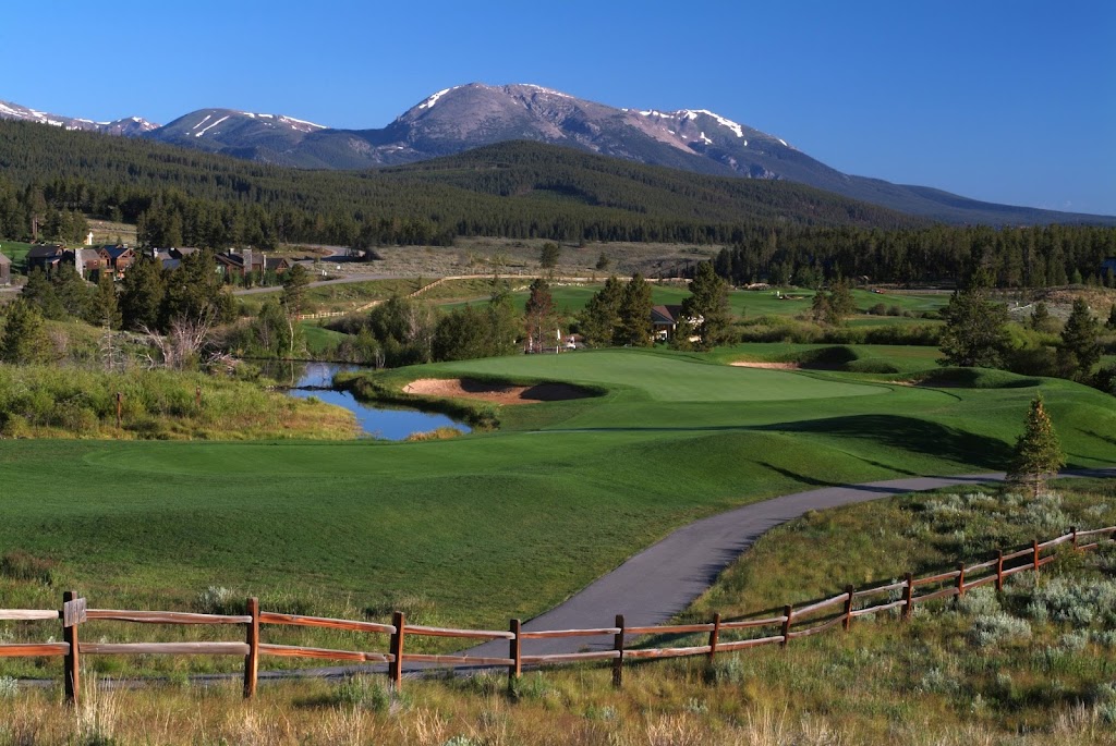 Panoramic view of a lush green golf course at Breckenridge Golf Club. Smooth