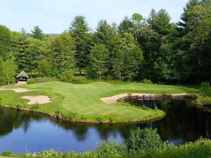 Panoramic view of a lush green golf course at Bretwood Golf Course. Smooth