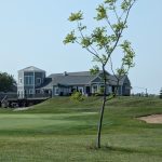 Panoramic view of a lush green golf course at Briarwood Golf Club. Smooth