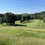 Panoramic view of a lush green golf course at Bridgeport Country Club. Smooth