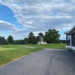 Panoramic view of a lush green golf course at Bridgton Highlands Country Club. Smooth