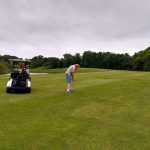 green grass with the flag in the hole.