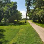 Panoramic view of a lush green golf course at Briggs Woods Golf Course. Smooth