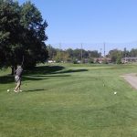 green grass with the flag in the hole.