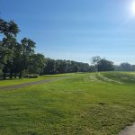 Panoramic view of a lush green golf course at Bright Grandview Golf Course. Smooth