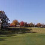 Panoramic view of a lush green golf course at Brittany Golf Course. Smooth