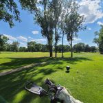 Panoramic view of a lush green golf course at Brookland Golf Park. Smooth