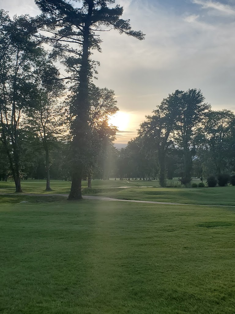 Panoramic view of a lush green golf course at Brookmeadow Country Club. Smooth