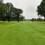 Panoramic view of a lush green golf course at Brown County-Riverdale Golf Course. Smooth