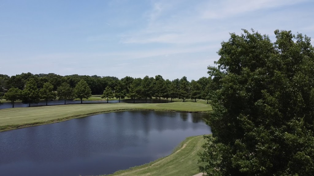 Panoramic view of a lush green golf course at Brownstone Country Club & Resort. Smooth