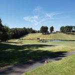 Panoramic view of a lush green golf course at Brushy Mountain Golf Club. Smooth