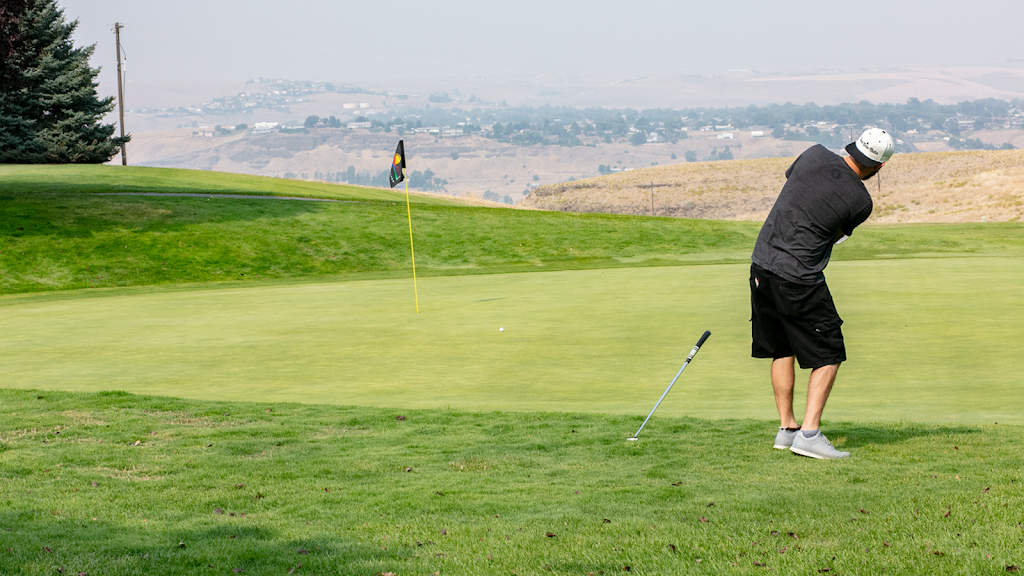 Panoramic view of a lush green golf course at Bryden Canyon Public Golf Course. Smooth