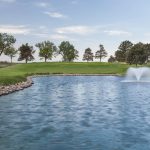 Panoramic view of a lush green golf course at Buffalo Dunes Golf Course. Smooth