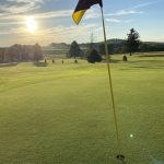 green grass with the flag in the hole.