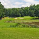 Panoramic view of a lush green golf course at Bull Creek Golf Course. Smooth