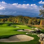 Panoramic view of a lush green golf course at Bull's Bridge Golf Club. Smooth