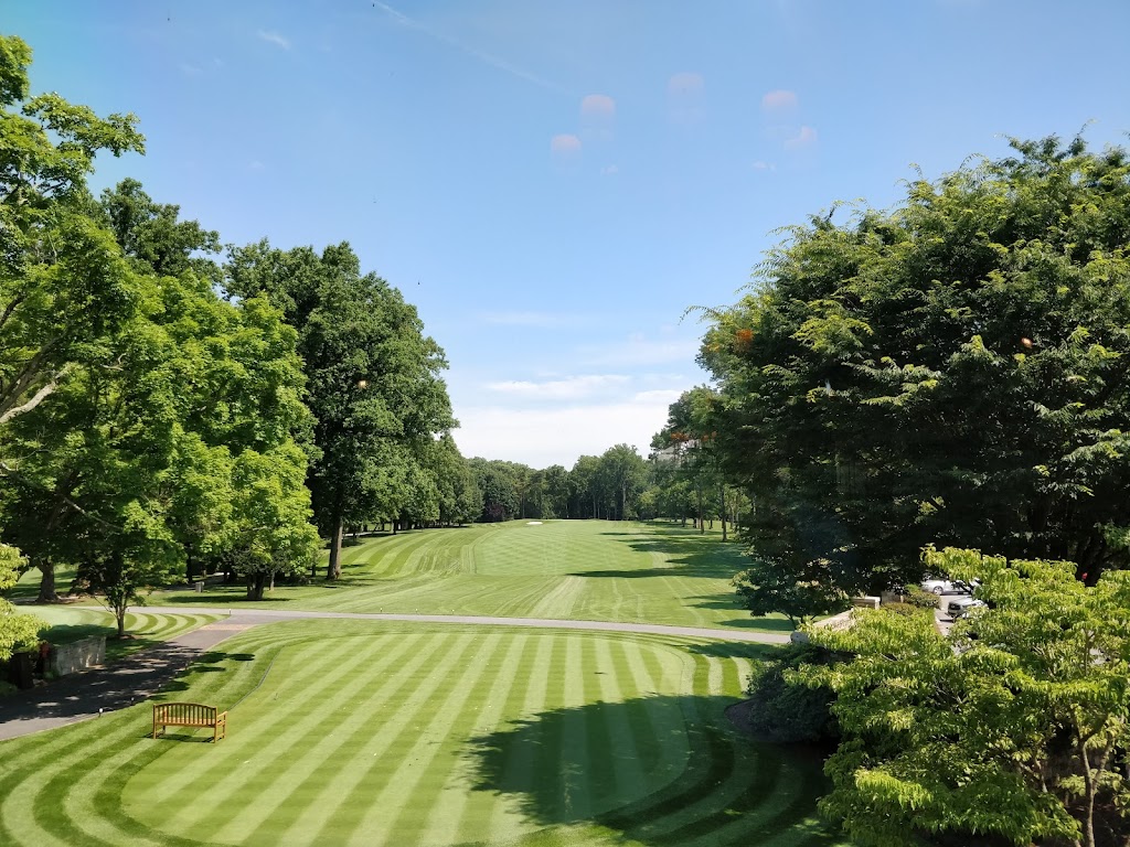 Panoramic view of a lush green golf course at Burning Tree Club. Smooth