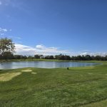 Panoramic view of a lush green golf course at Butler National Golf Club. Smooth