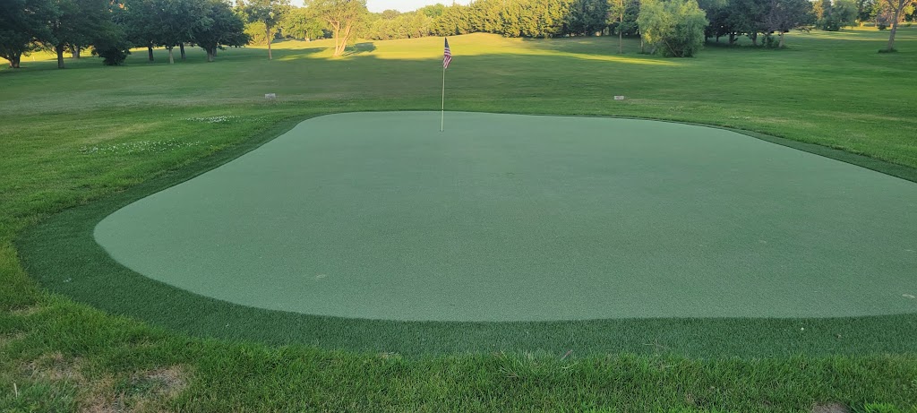 green grass with the flag in the hole.