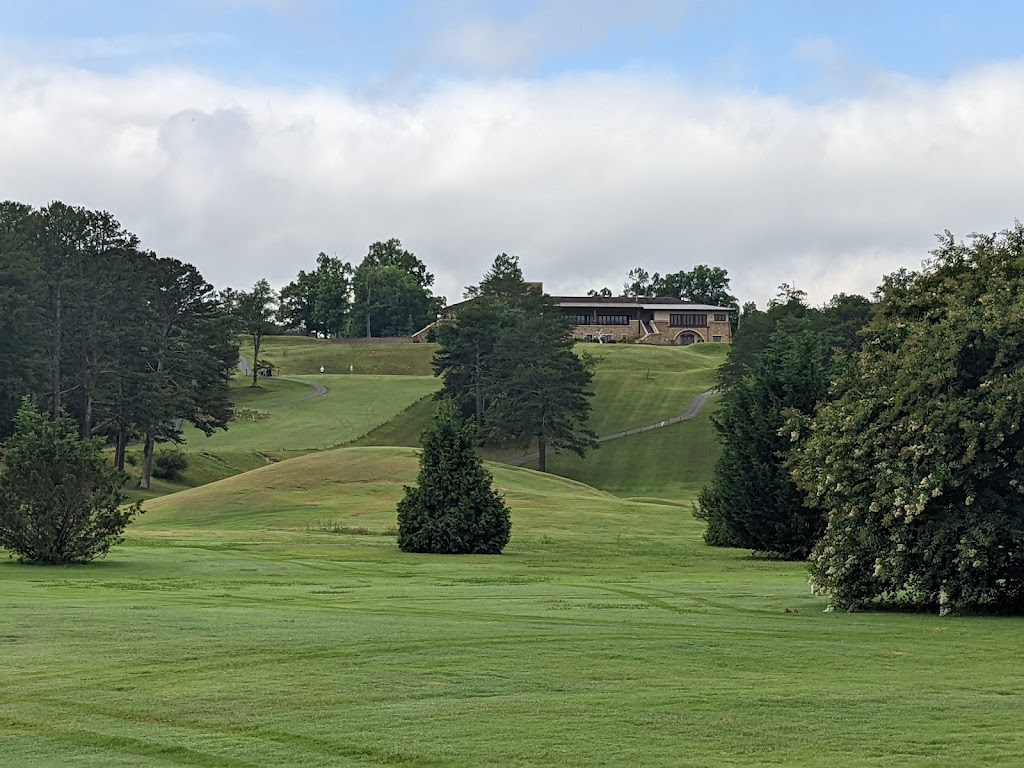 Panoramic view of a lush green golf course at Butternut Creek Golf Course. Smooth