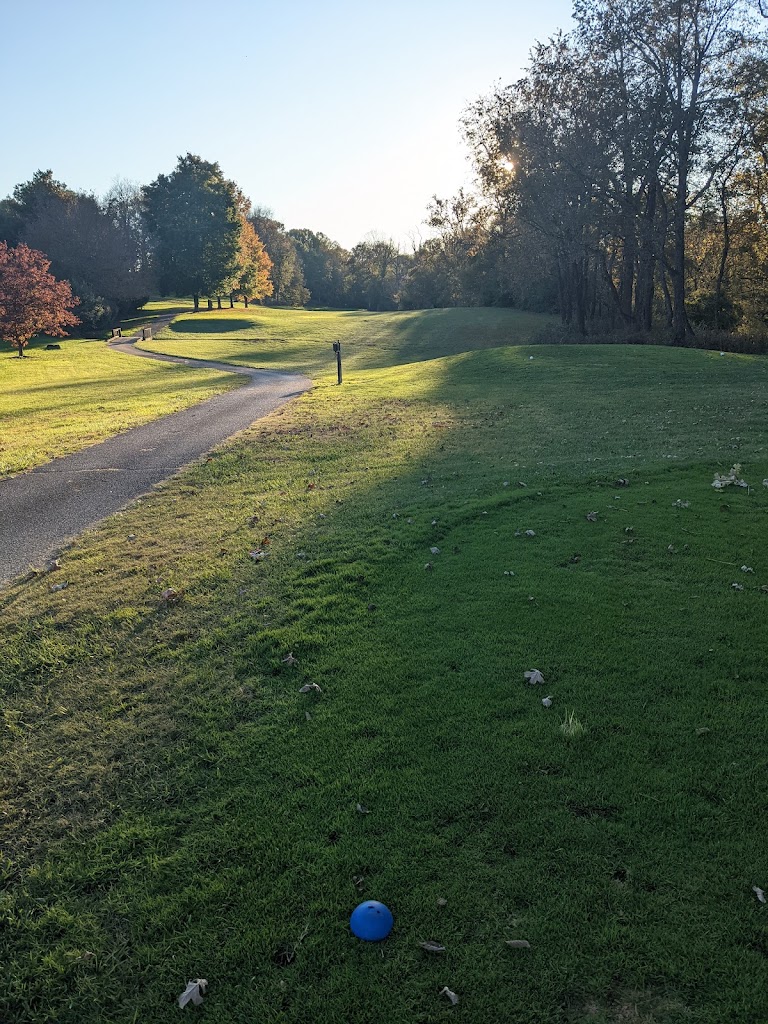 Panoramic view of a lush green golf course at CANEWOOD GOLF COURSE. Smooth