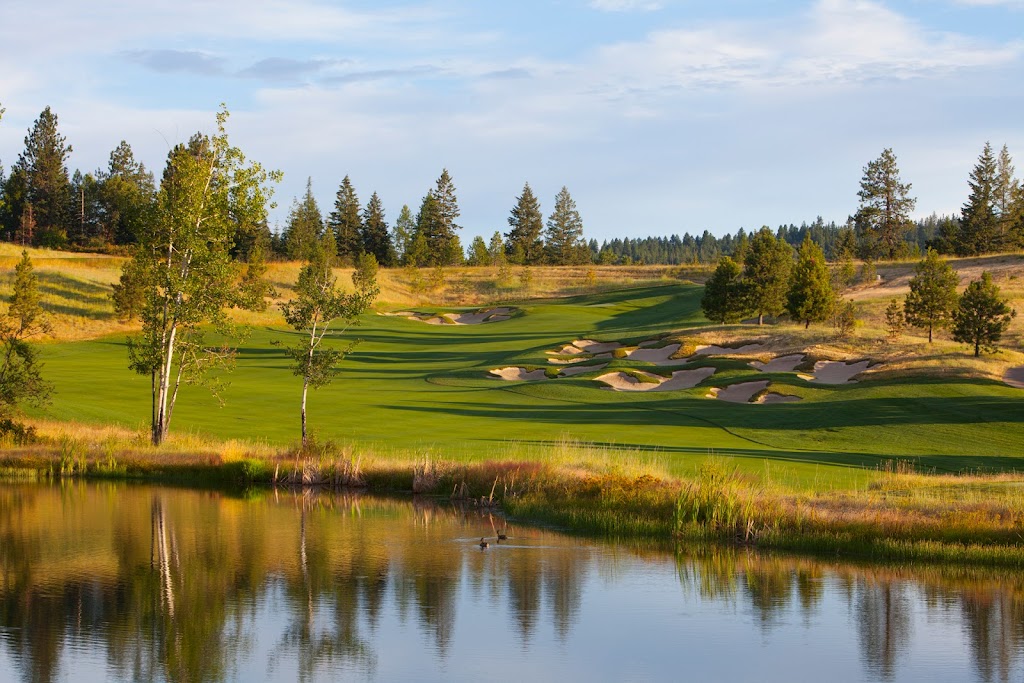 Panoramic view of a lush green golf course at CDA National Reserve Private Club and Golf Course. Smooth