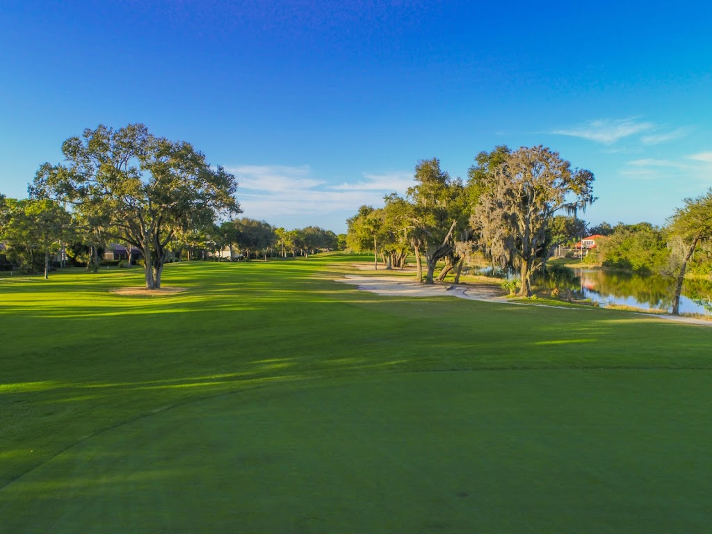 Panoramic view of a lush green golf course at Calusa Lakes Golf Club. Smooth