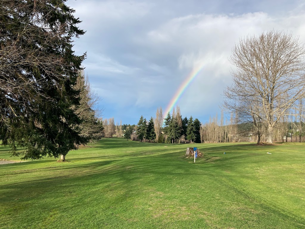 Panoramic view of a lush green golf course at Camas Prairie Park. Smooth