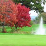 Panoramic view of a lush green golf course at Campbell's Scottish Highlands Golf Course & Driving Range. Smooth