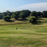 Panoramic view of a lush green golf course at Candler Park Golf Course. Smooth
