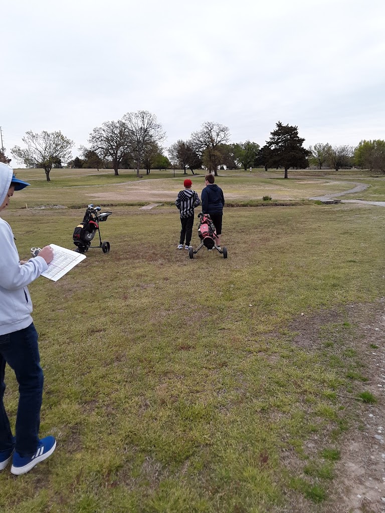 Panoramic view of a lush green golf course at Caney Golf Club. Smooth