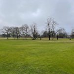 Panoramic view of a lush green golf course at Cantiague Golf Course. Smooth
