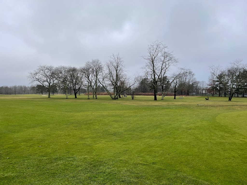 Panoramic view of a lush green golf course at Cantiague Golf Course. Smooth